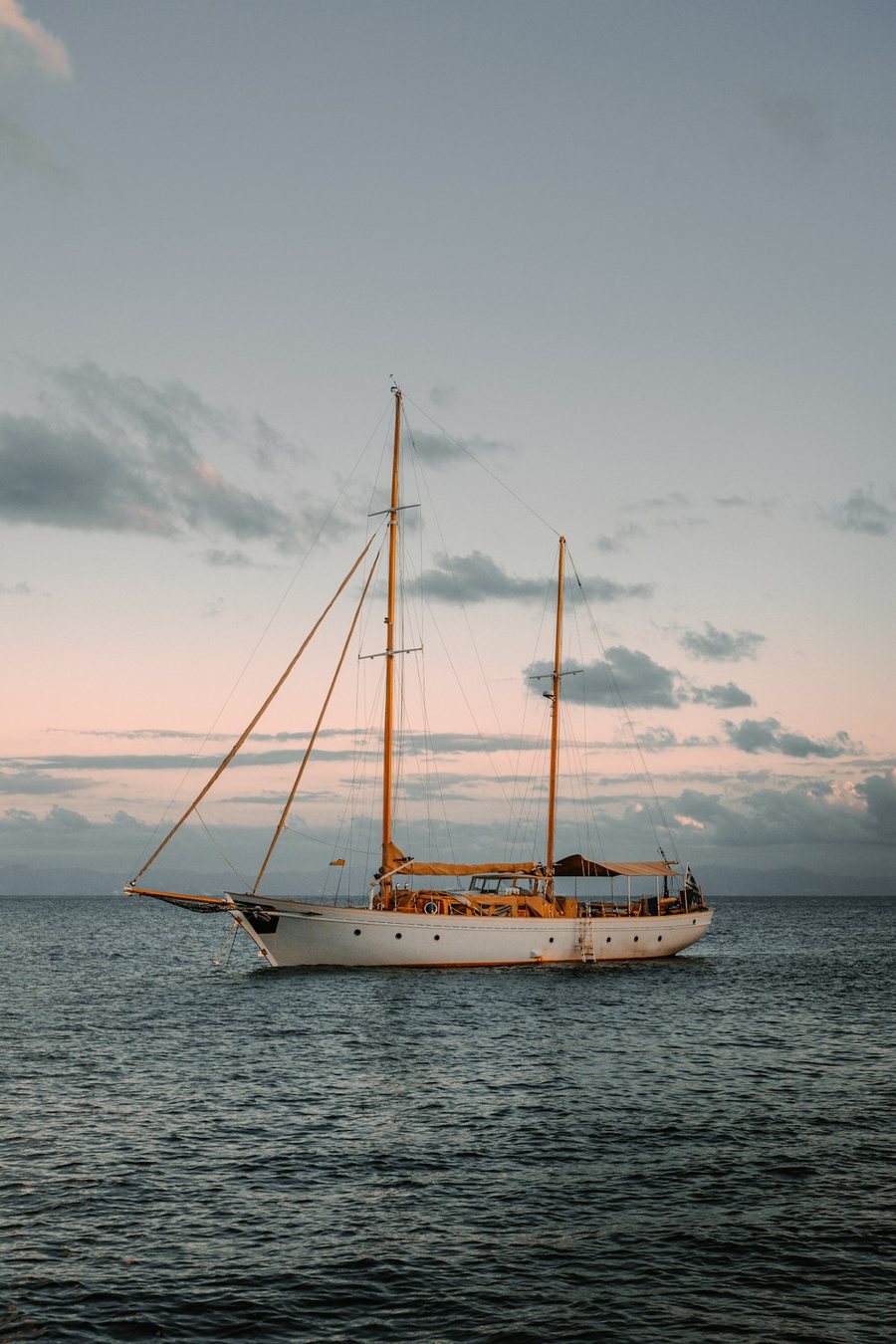 Two-masted classic ketch at anchor at dusk